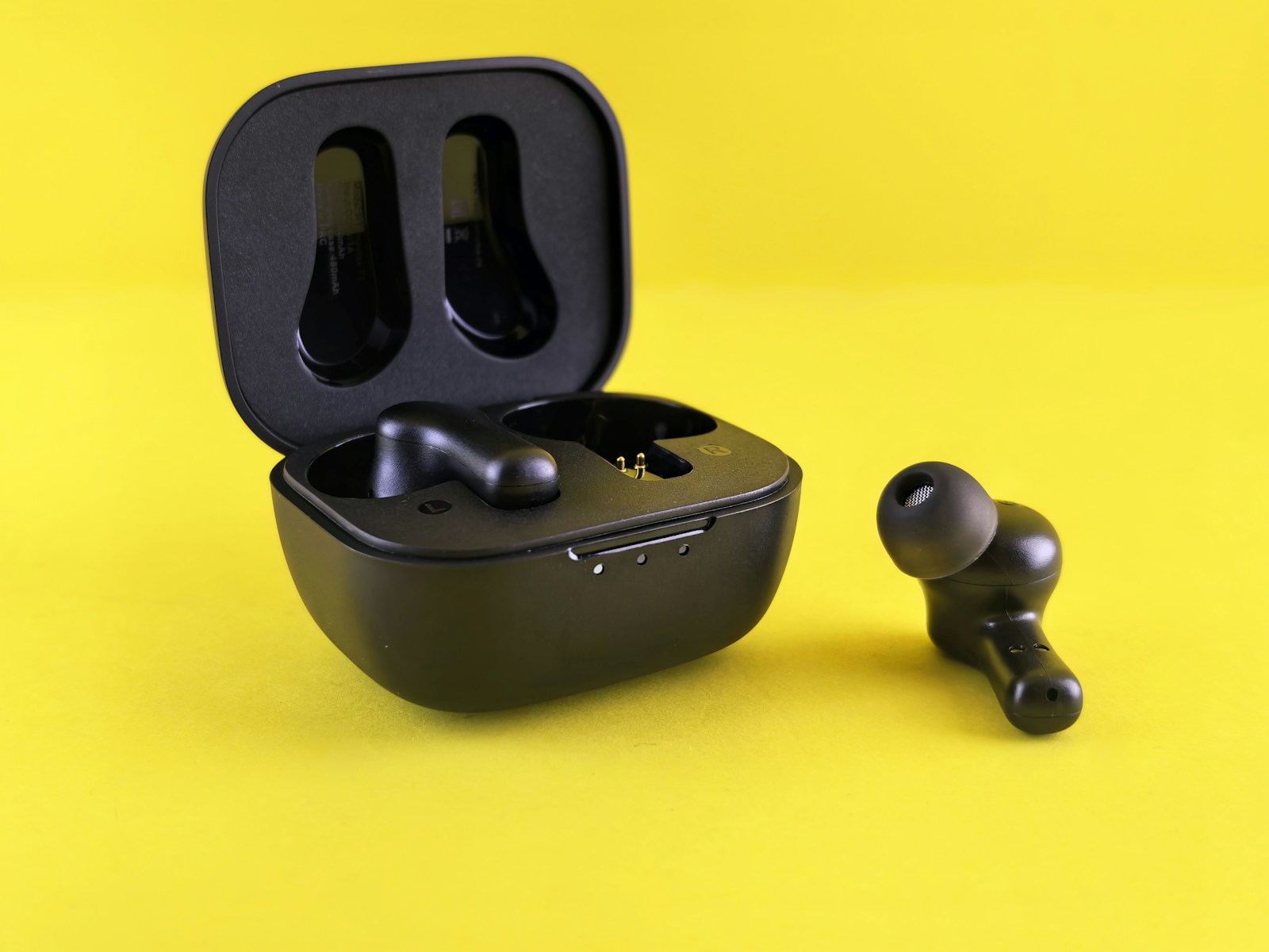 Black earbuds and their charging case.