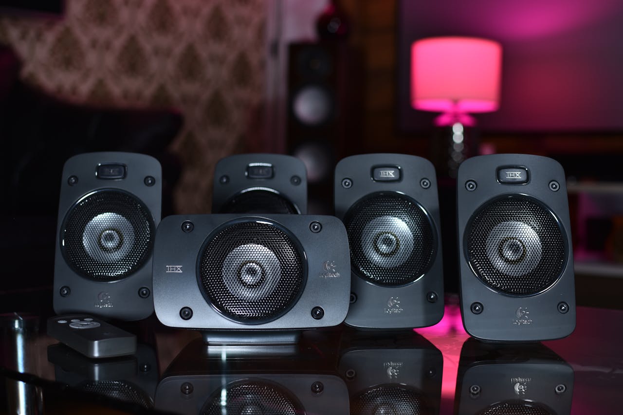 about-img A close-up of a surround sound speaker system with remote, perfect for modern home entertainment.