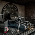 Close-up of an intricate car audio and hydraulic setup with metal components.